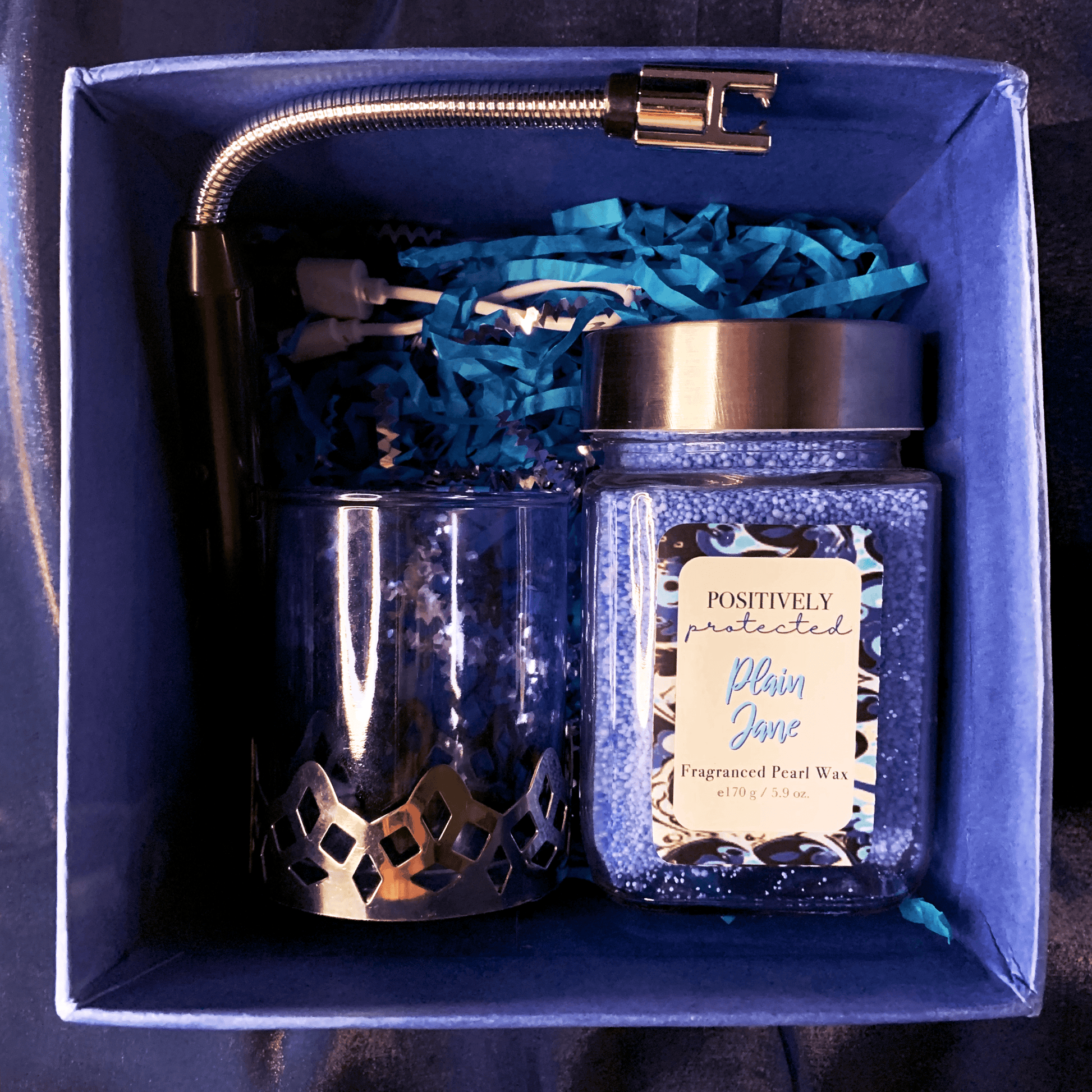 Bare Scentuals Candle Gift Set Product Layout Inside Box containing blue pearl wax, glass jar, glass and metallic container and an electric lighter