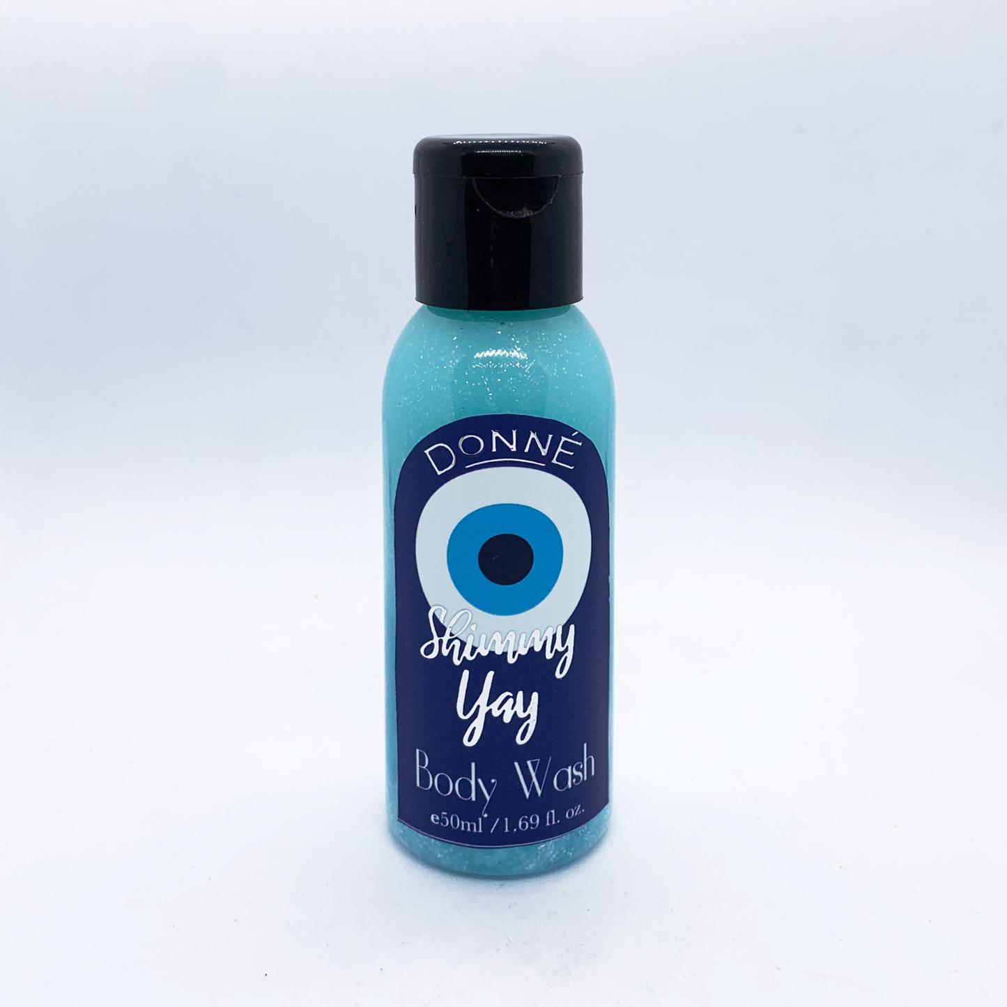 Shimmy Yay - a body wash against a white background with a black lid, evil eye labels with silver accents