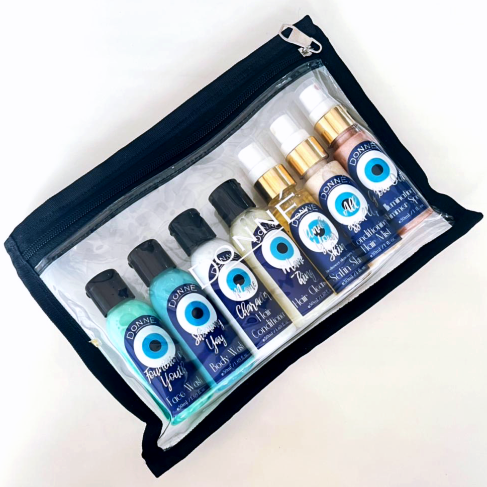 Travel Kit with Shampoo Conditioner Face and Body Wash Hair Serum shimmer spray and moisturising spray panned out inside the PVC pouch
