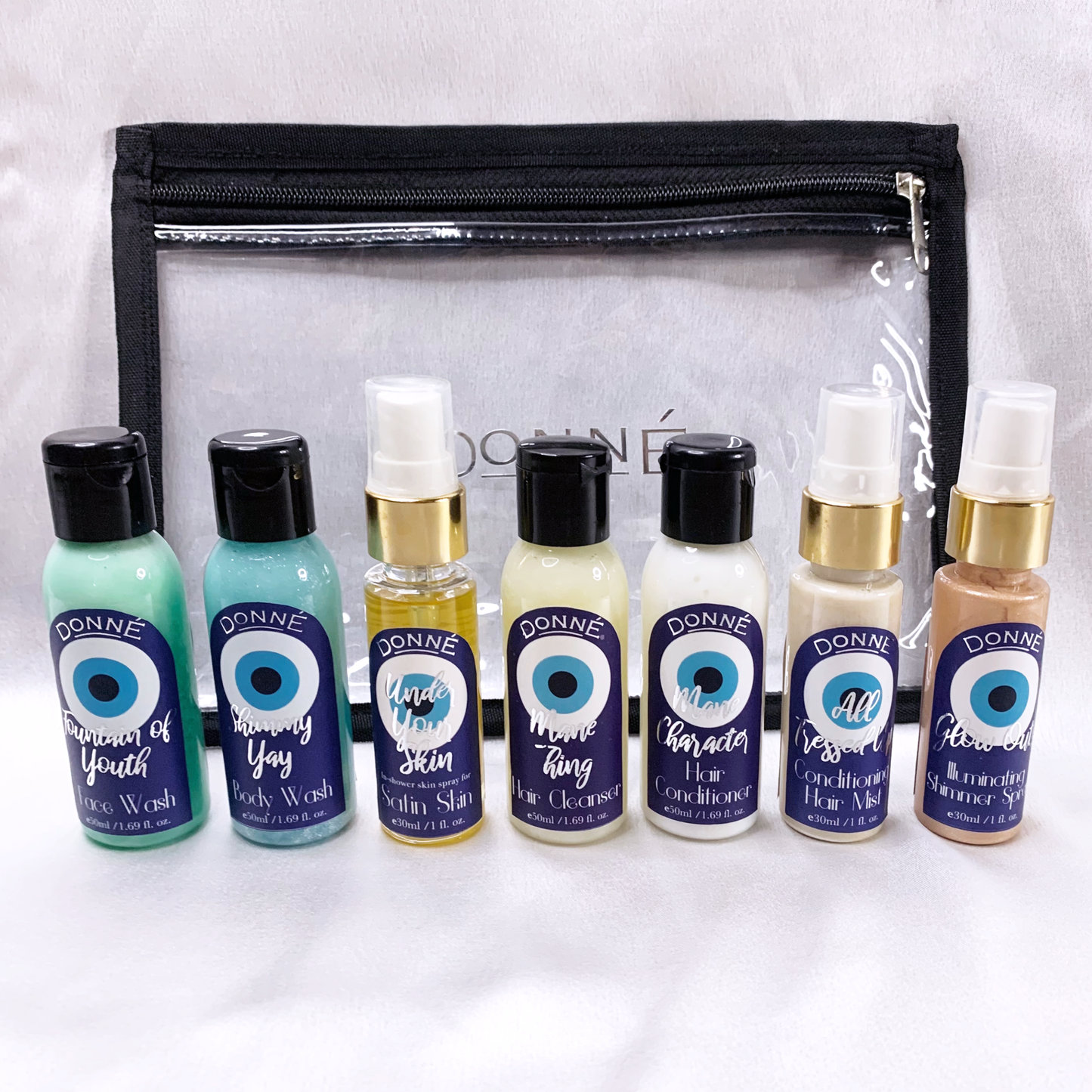face wash, body wash, conditioner, shampoo, moisturising spray shimmer spray and a hair serum mist in front of a travel pouch