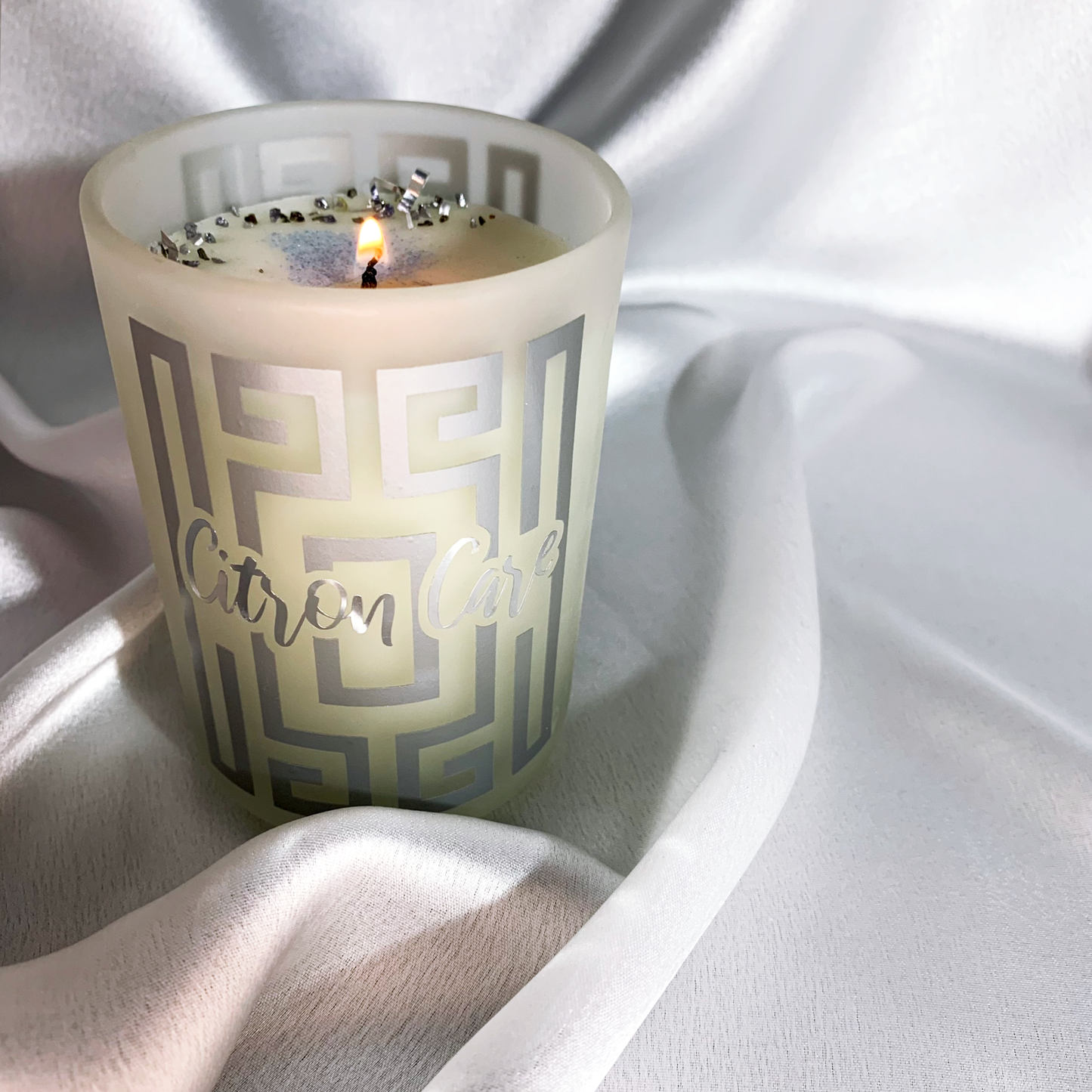 Lit container candle with luxurious design for citrus scent candle, crushed glass, glitter and potpourri embedded 